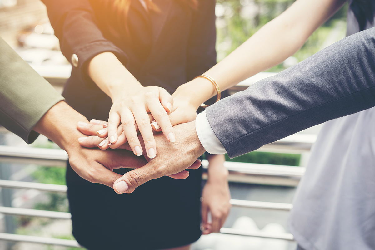 Close up of business people hands together. Teamwork concept.